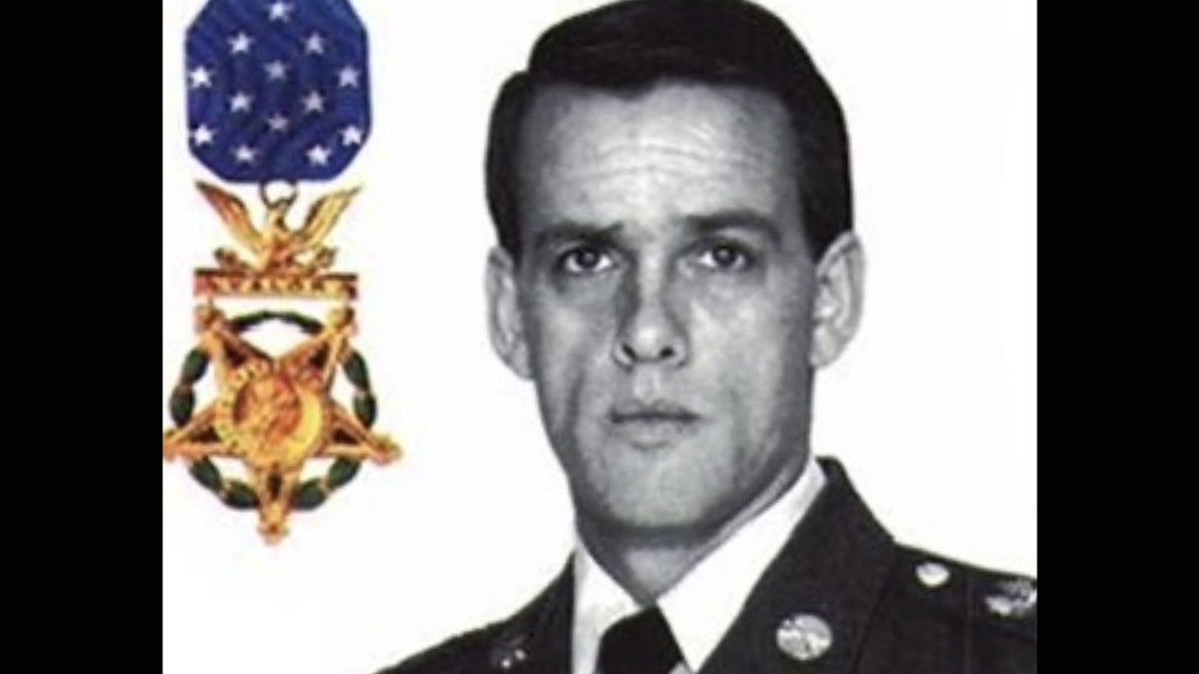 Portrait of Master Sgt. Gary Gordon in U.S. Army uniform beside the Medal of Honor emblem, recognized for service during the Somalia conflict.