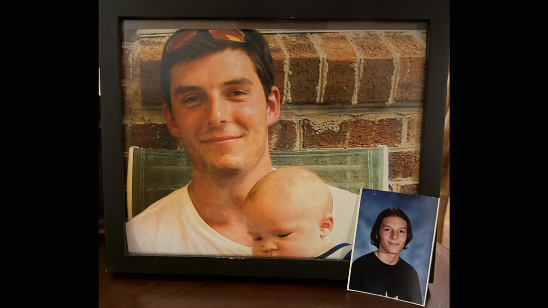 Framed photograph of Staff Sgt. Justin Marquez holding a baby, displayed beside a smaller portrait photo, honoring his military service during the Afghanistan conflict.