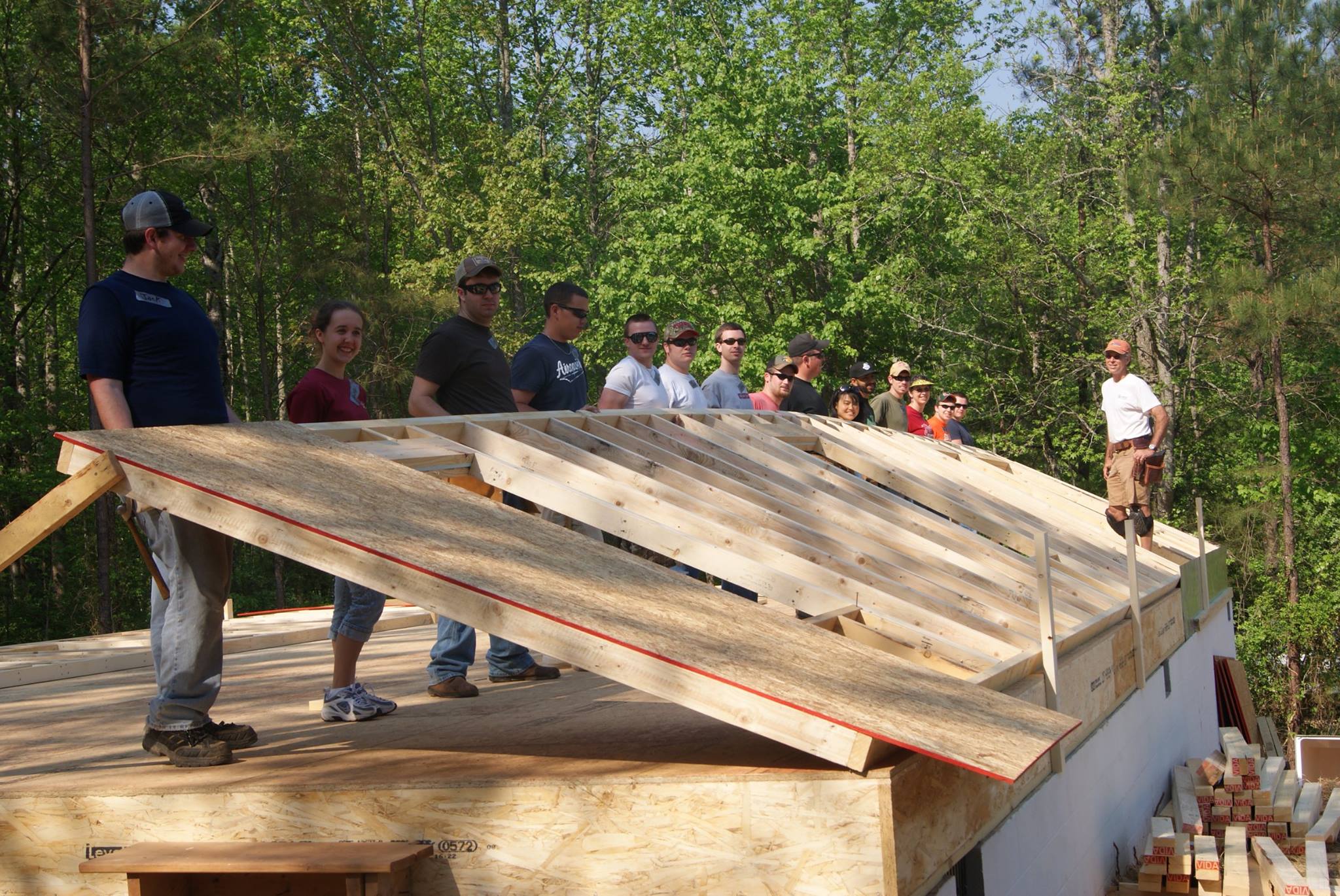 Student raising building frame