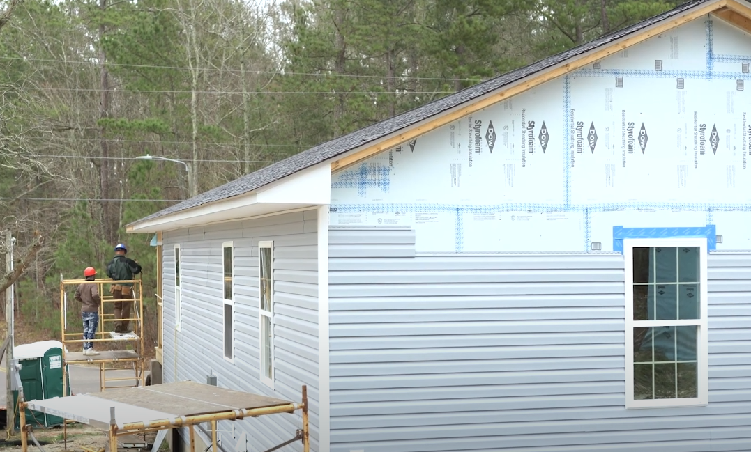 Two students building house