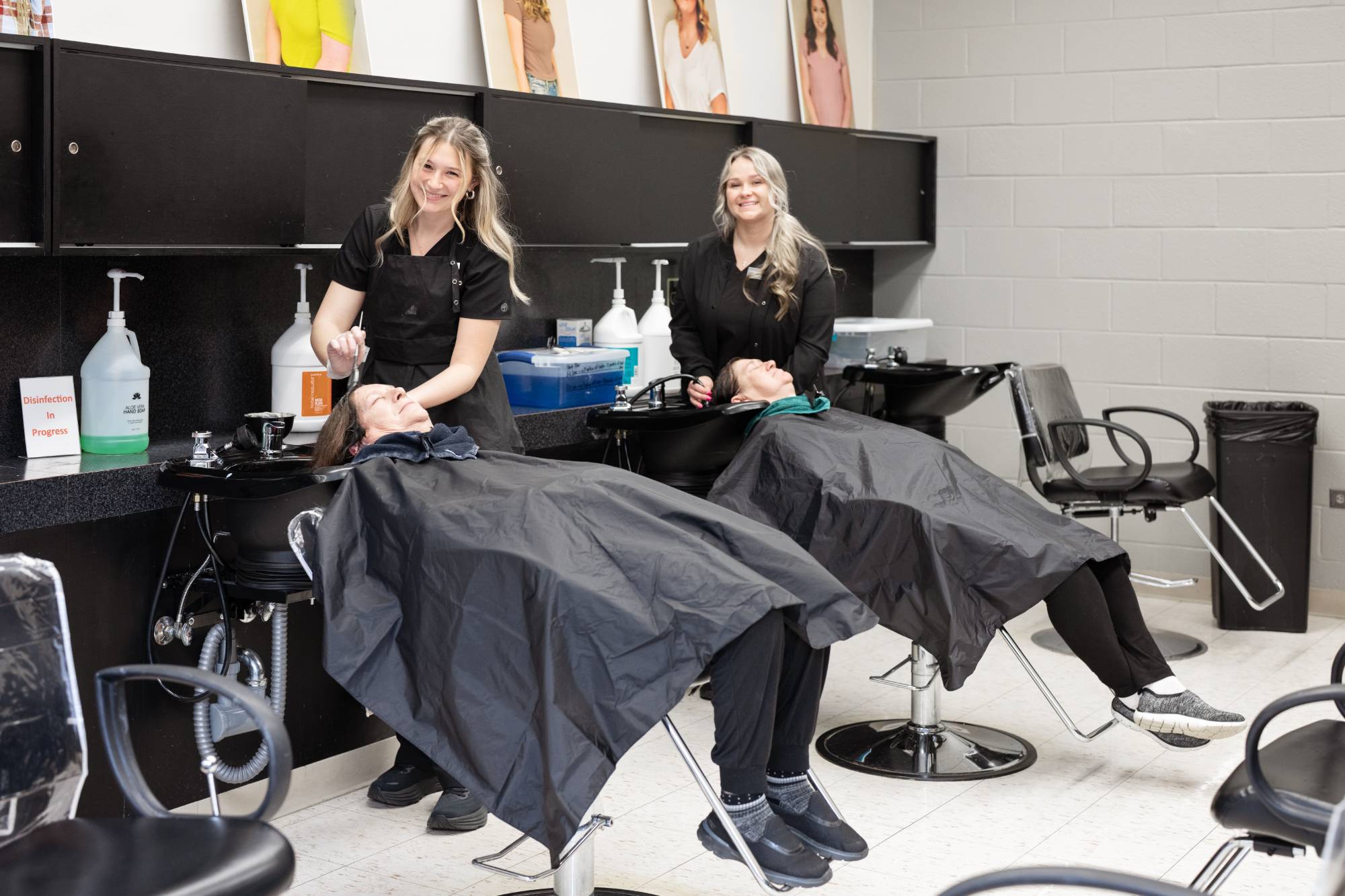 cosmetology students working in classroom