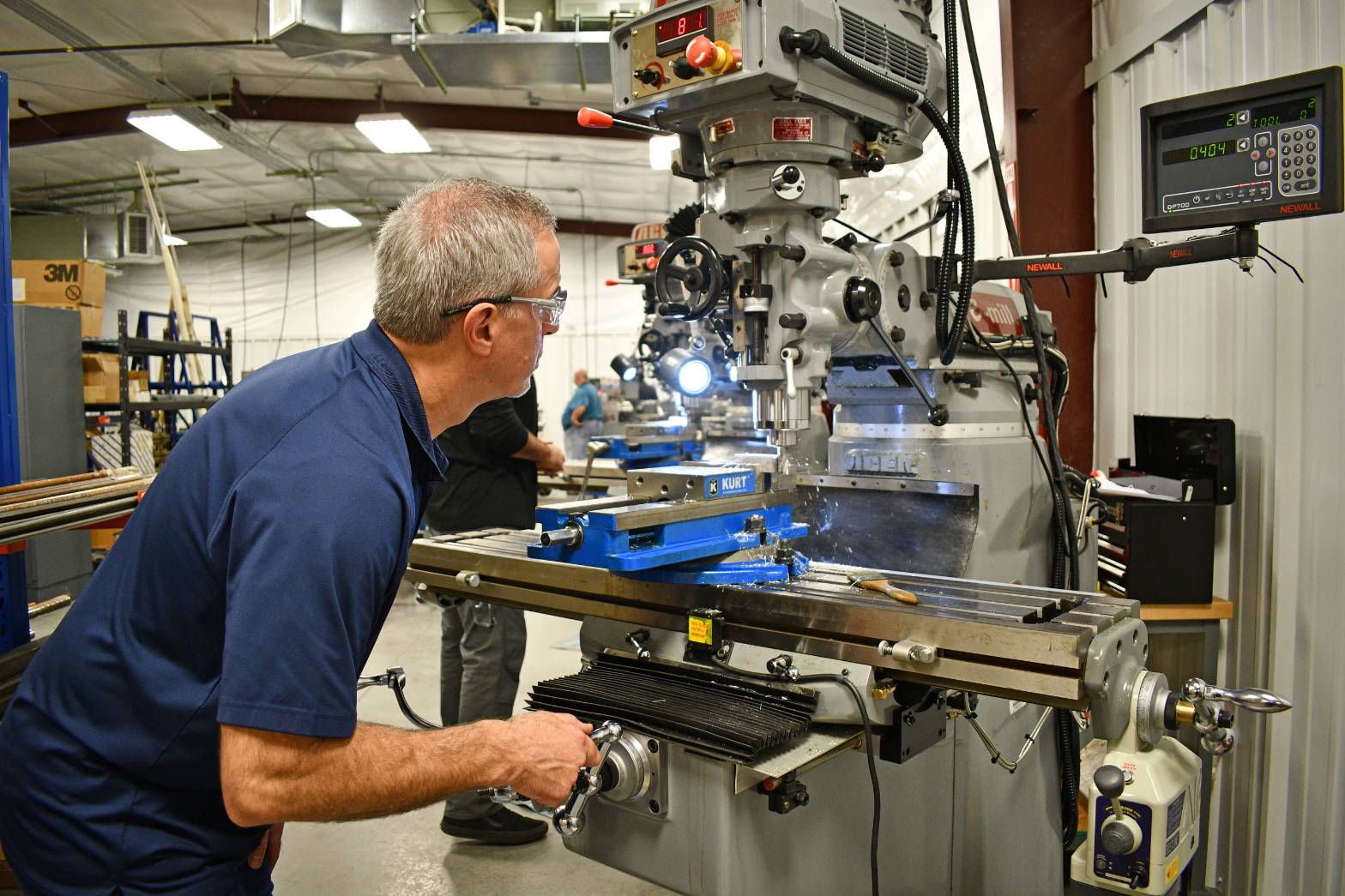 professor demonstrating machining equitment