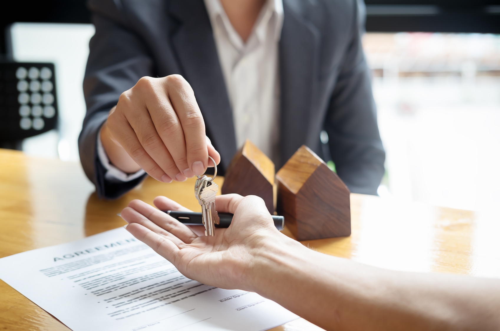 Real estate agent handing over keys