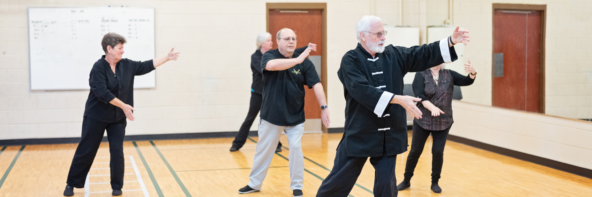 Participants practice tai chi movements during a personal enrichment class at Sandhills Community College.