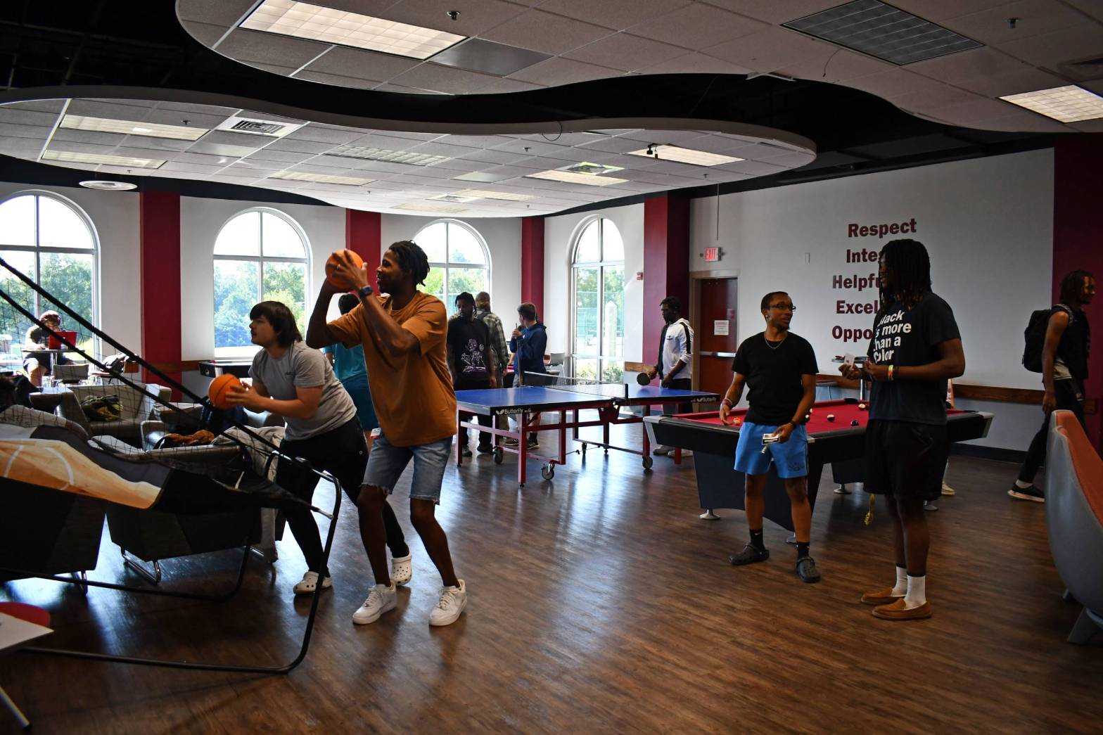 Students playing pool and basketball