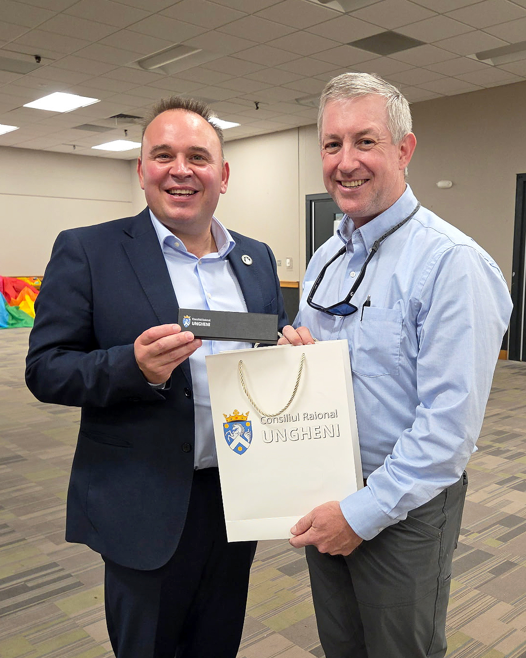 Sandhills Community College President Alexander “Sandy” Stewart greets Dionisie Trnovschi, president of Ungheni province in Moldova, during a visit to North Carolina.
