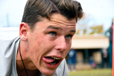JROTC cadet grimaces with determination while holding a plank position during a physical fitness event at the Viking Drill Meet at Sandhills Community College.
