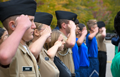 JROTC cadets stand in formation and salute during the Viking Drill Meet at Sandhills Community College.