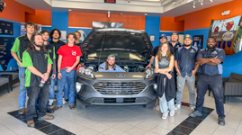 Collision Repair Students with Donated Ford Escape Sandhills Community College Collision Repair students pose around a 2021 Ford Escape inside the automotive shop as they prepare it for conversion into a rehabilitation training vehicle for The Lodge at Sandhills Carolina.
