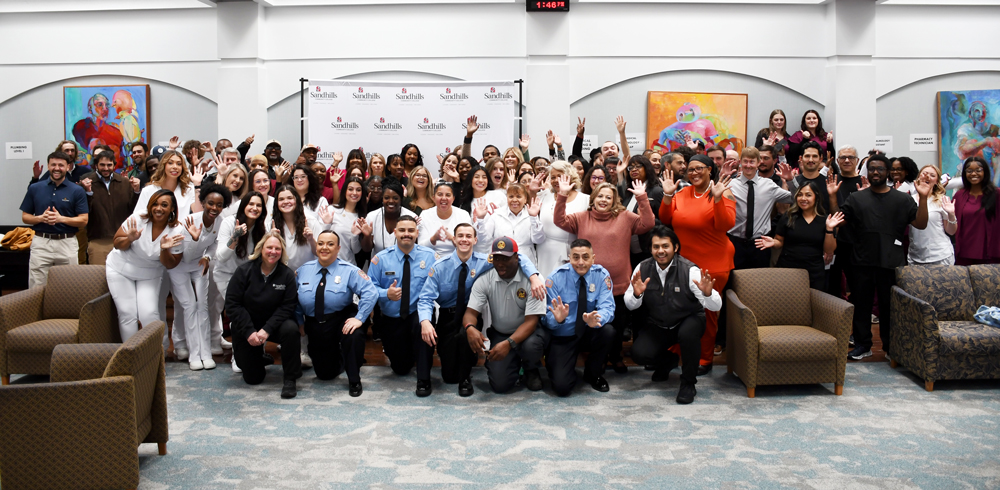 Group photo of Sandhills Community College Workforce Continuing Education graduates gathered at the commencement ceremony, celebrating completion of programs across healthcare, skilled trades, and public safety.