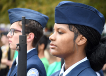 Air Force JROTC cadet stands in uniform with focused attention during the Viking Drill Meet at Sandhills Community College.