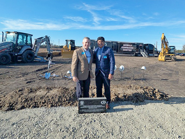 Dr. Sandy Stewart stands with a Pennsylvania Transformer Technology representative at the December 10, 2025 groundbreaking in Hoke County.