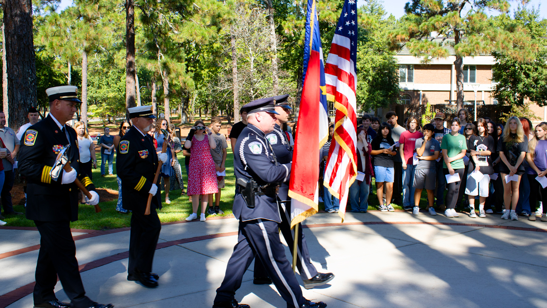 Fire department color guard carrying the American and North Carolina flags during the 9/11 remembrance ceremony at Sandhills Community College.