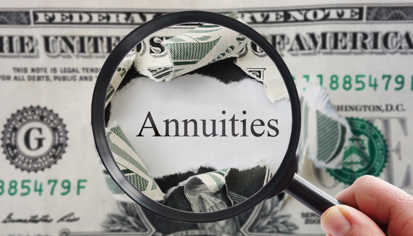 The word "annuities" is magnified through a dollar bill