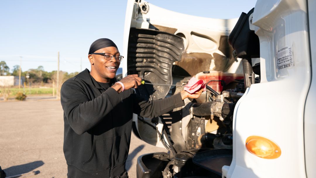 Pictured is a SCC CDL student checking the oil.
