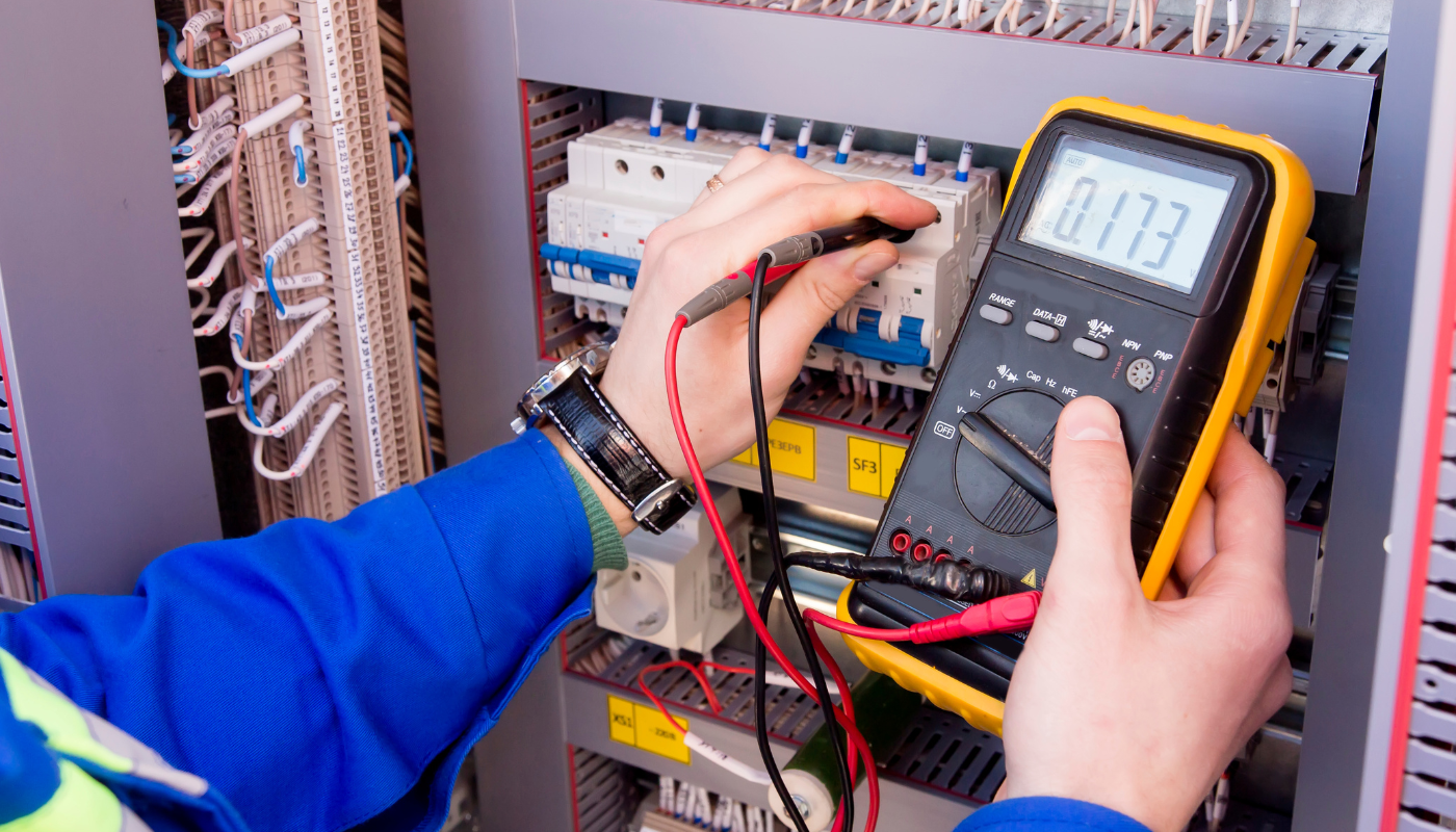 Electrician using a multimeter