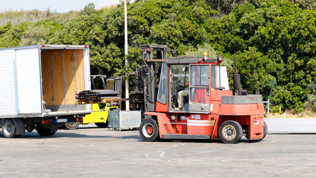 Pictured is a person on a forklift moving material.