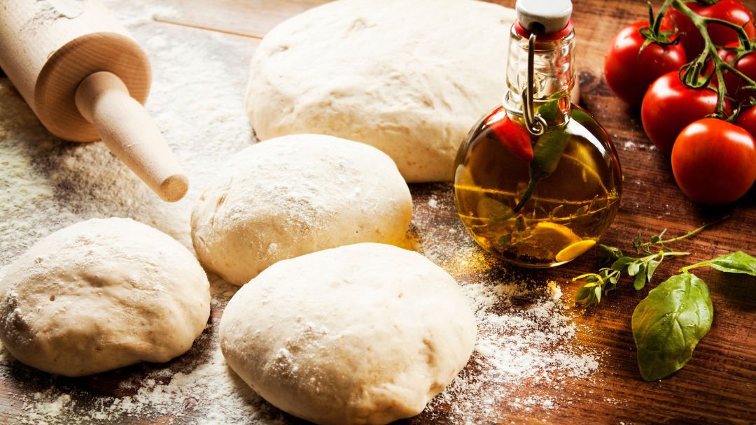 Pictured is pizza dough being made. 