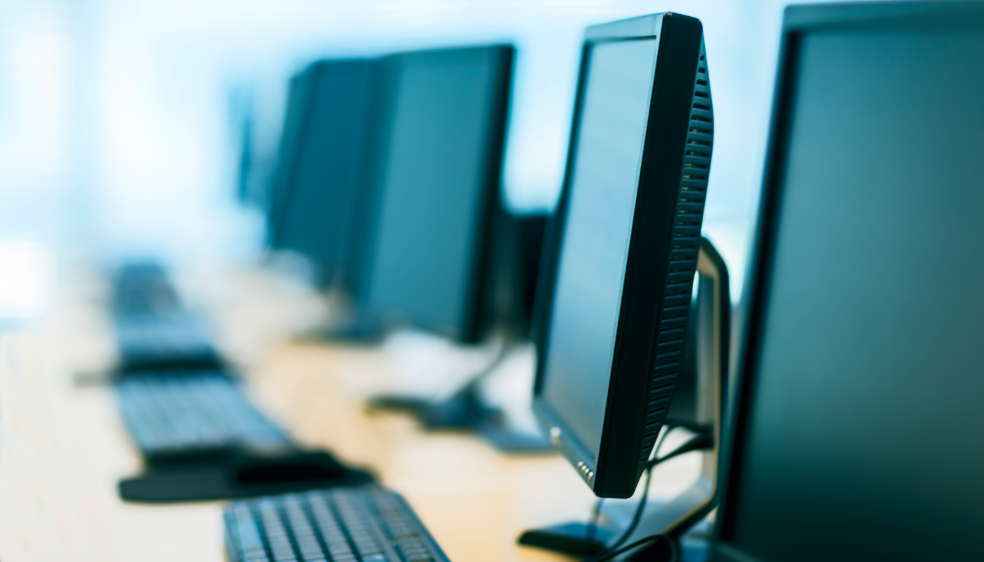 Pictured are several computers in a row. 