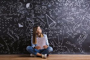 Student sitting in front of chalkboard