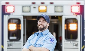 Paramedic standing outside an ambulance.