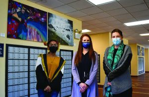 Art student Tya McAlister, Kim Jolly, and Lori Lorion in the Pinehurst Post Office.