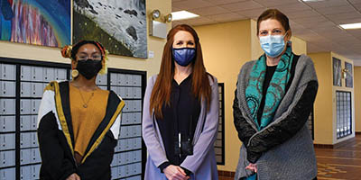Art student Tya McAlister, Kim Jolly, and Lori Lorion in the Pinehurst Post Office.