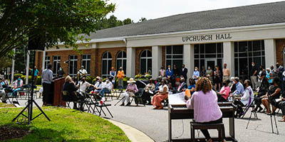 Crowd outside Upchurch Hall during the statue dedication for Dr. Thomas.